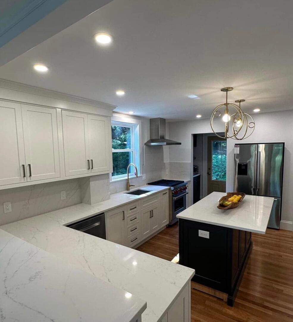 Kitchen with recessed lighting and pendant fixtures by Pro Electrical